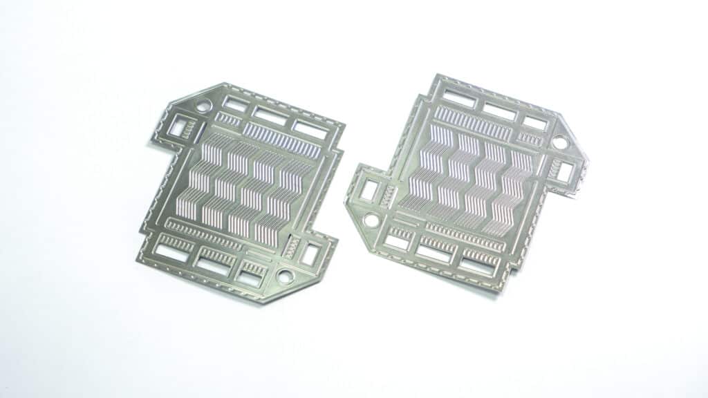 Stamped metallic bipolar plate halves for a hydrogen fuel cell stack