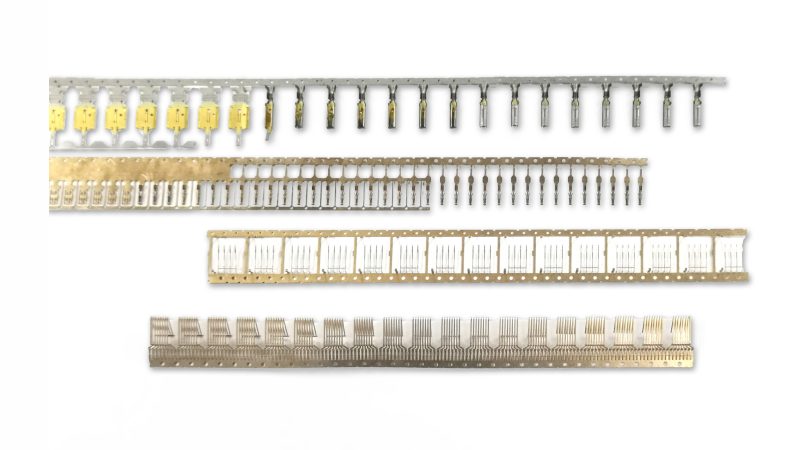 Stamped terminal and pin strips for connectors from SSP progressive-transfer hybrid and multi-station dies