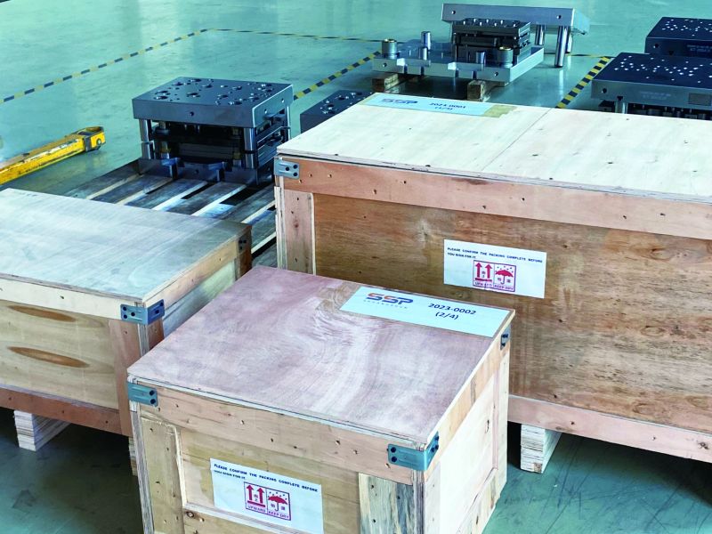 Wooden export crates labeled SSP, packed and ready to ship next to finished die sets